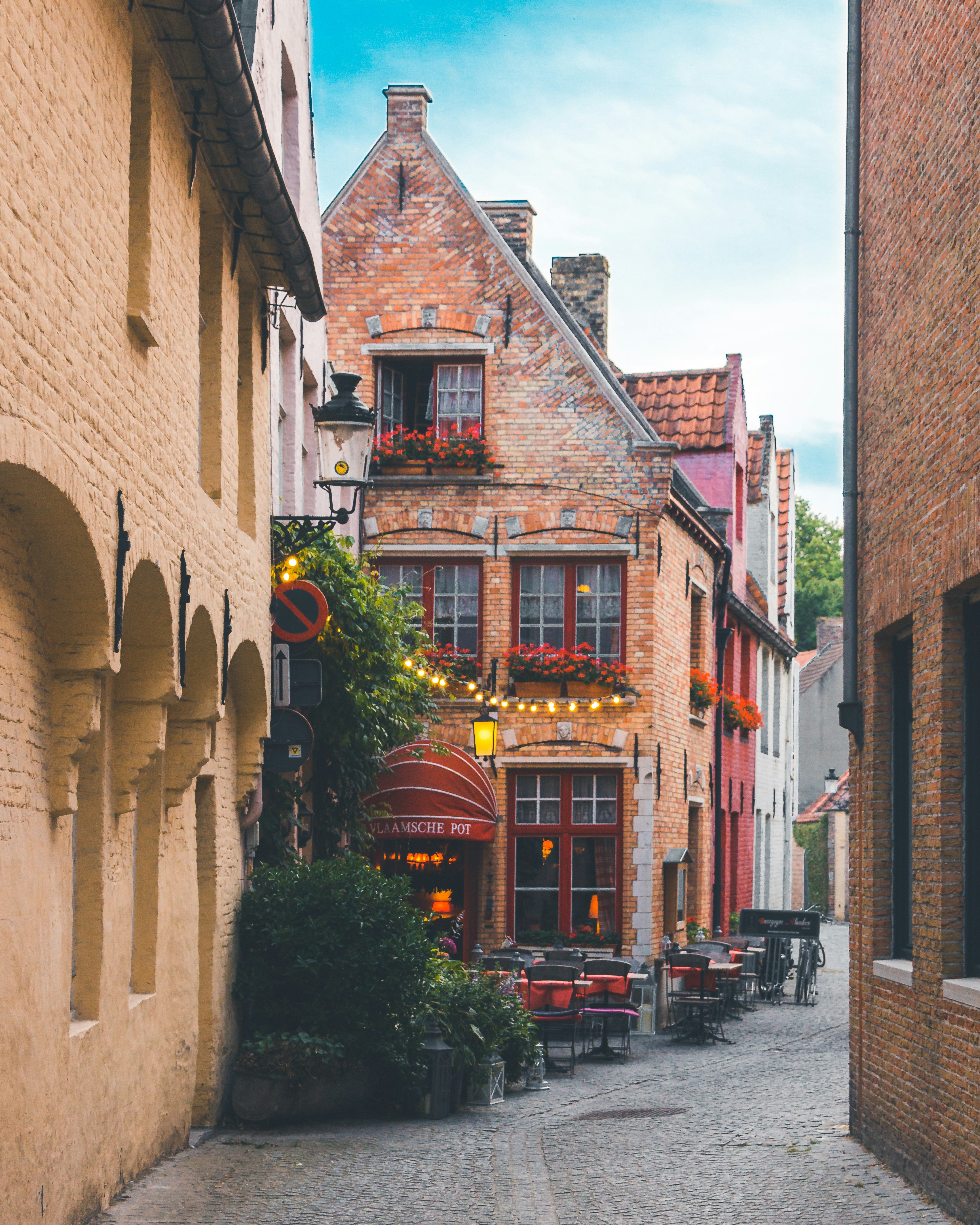 Bruges cobblestone alley with brick façades